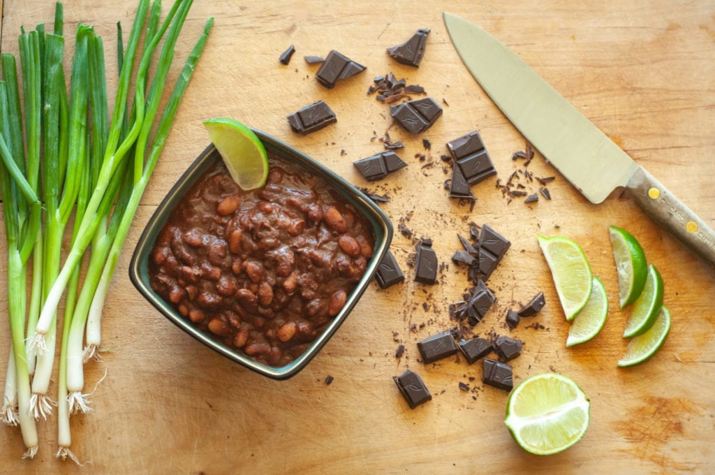 A display of prepared Chocolate Chili with Chipotle Peppers, garnished with a lime wedge.